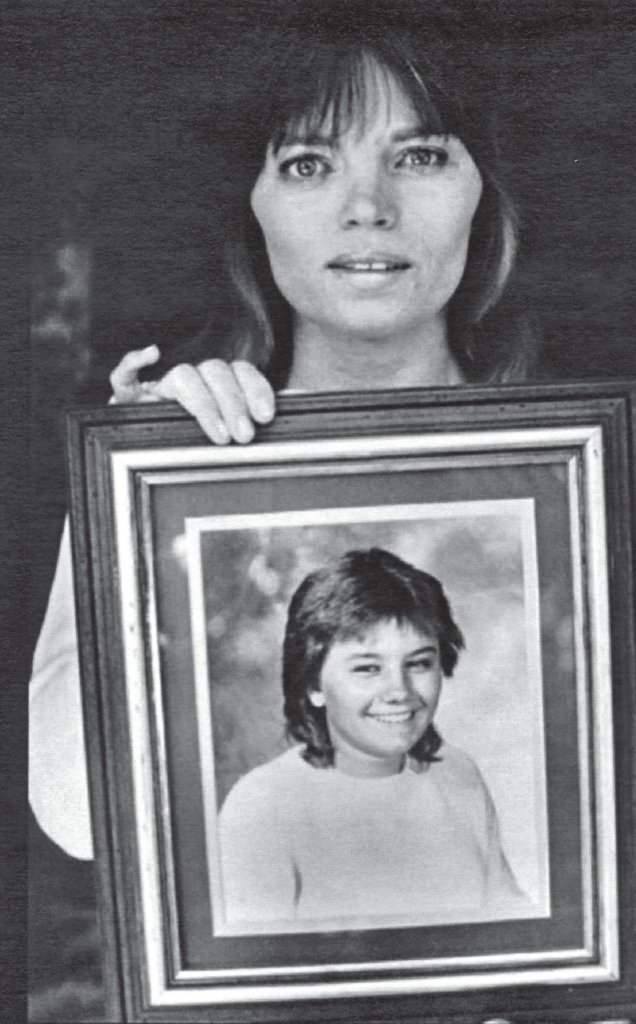 Shirley Faelz holding a photo of her daughter, Tina Faelz.
