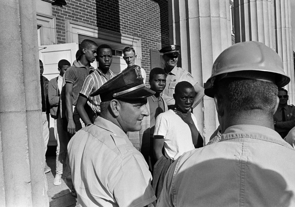 “Police watch as young African Americans are taken from the Natchez City Auditorium in October 1965. AP photo. Used with permission.”