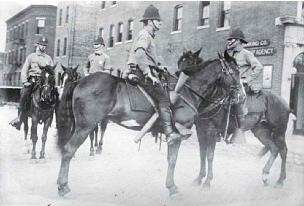 Four police officers on horses.